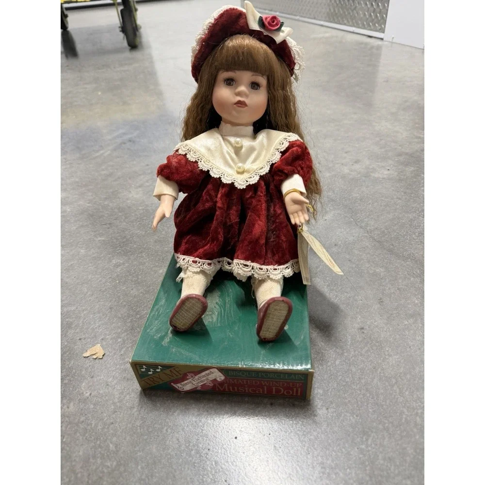 Dan Dee fine bisque porcelain animated wind-up musical doll, red dress